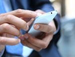 Close up of a man using mobile smart phone