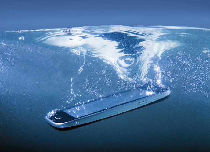 modern smartphone closeup thrown into water