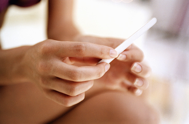 Young woman filing nails, close-up