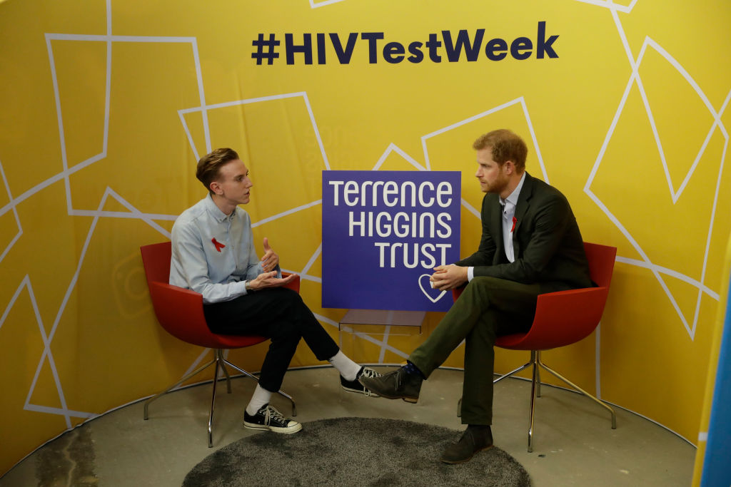 LONDON, ENGLAND - NOVEMBER 15:  Prince Harry (R) listens listens as Andrew Bates, 23, tells his story of his life after being diagnosed with HIV in 2015 during his visit to the opening of the Terrence Higgins Trust charity's HIV self-test pop-up shop in Hackney to launch National HIV Testing Week on November 15, 2017 in London, England. The charity aims to end the transmission of HIV in the UK and empower and support people living with HIV to lead healthy lives. (Photo by Matt Dunham - WPA Pool/Getty Images)