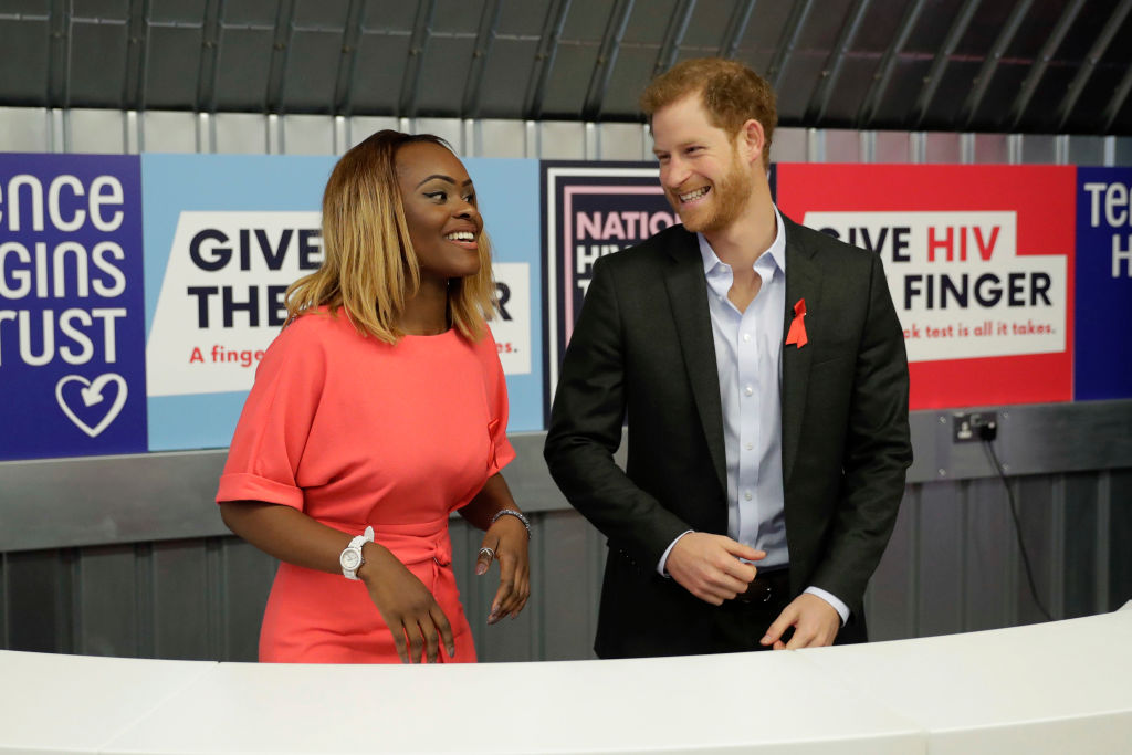 LONDON, ENGLAND - NOVEMBER 15:  Yvette Twagiramariya, one of the faces of the It Starts With Me campaign, laughs with Britain's Prince Harry before demonstrating an HIV self-test kit, during his visit to the opening of the Terrence Higgins Trust charity's HIV self-test pop-up shop in Hackney to launch National HIV Testing Week on November 15, 2017 in London, England. The charity aims to end the transmission of HIV in the UK and empower and support people living with HIV to lead healthy lives. (Photo by Matt Dunham - WPA Pool/Getty Images)